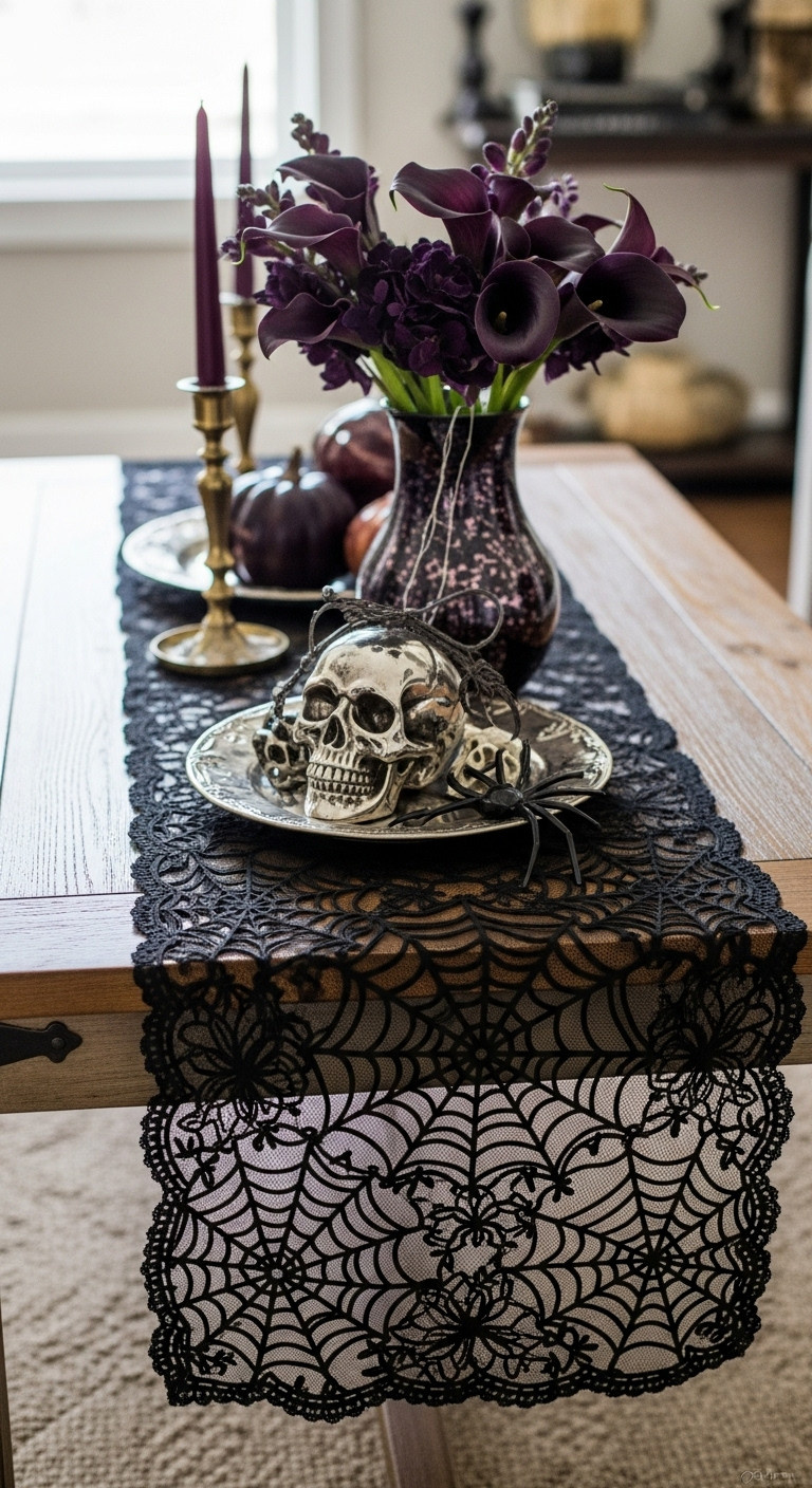 Black lace spiderweb table runner on dark wood with a silver skull and dark florals for spooky chic Halloween decor